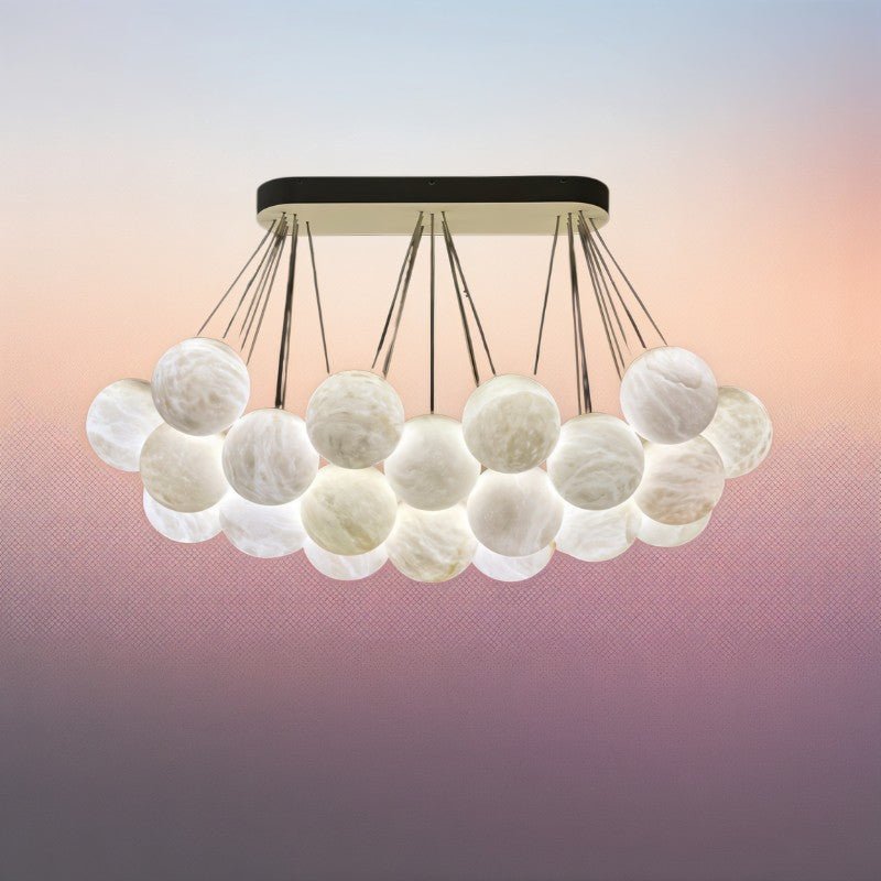 The lit globes packed in two layers, warm light through the veined stone
