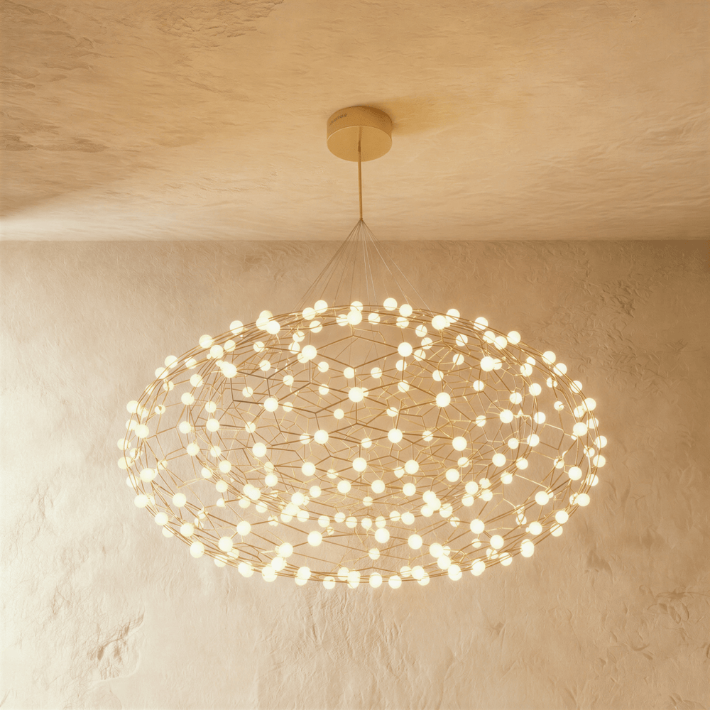 A flattened cloud of gold wire lattice studded with dozens of small white globes