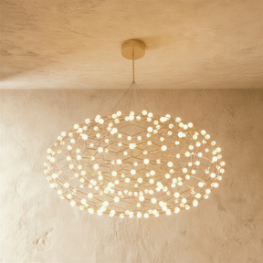A flattened cloud of gold wire lattice studded with dozens of small white globes
