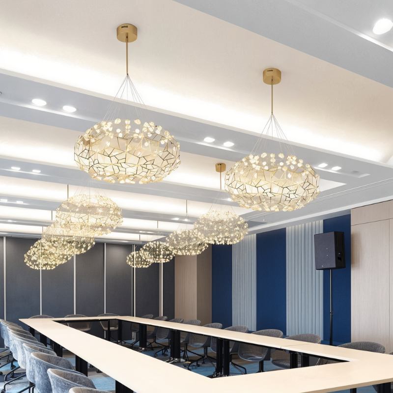 Several of the clouds lit in a row above a long meeting table and its chairs
