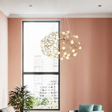 The cloud lit beside a window on a pink wall with a green chair and a plant