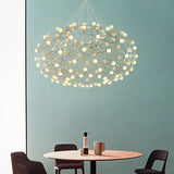 The cloud lit against a teal wall above a round table and two chairs