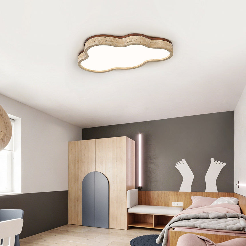 Cloud shaped ceiling light lit in a child bedroom with a gray wall and wood furniture