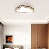 Travertine rimmed cloud ceiling light above a bed with a wardrobe and a framed poster