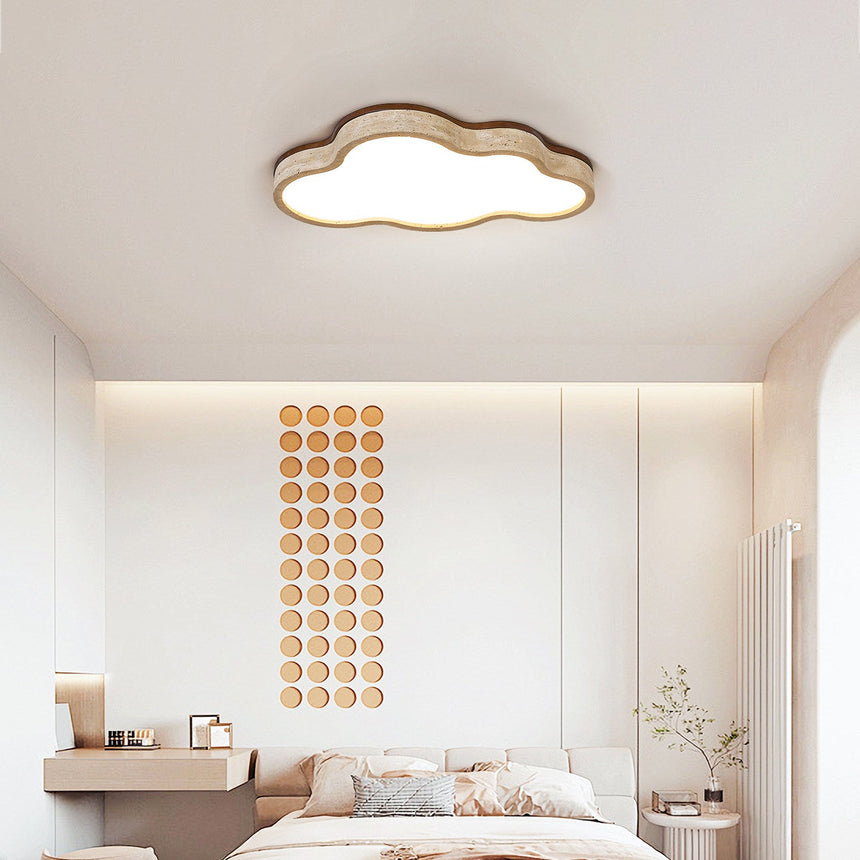 Cloud ceiling fixture lit in a bedroom with a beaded wall hanging and pale bedding