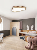 Cloud ceiling light in a child room with a sloped ceiling and a soft toy on the floor
