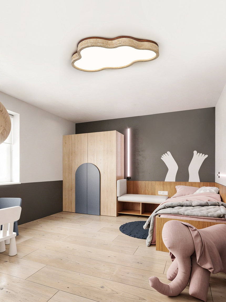 Cloud ceiling light in a child room with a sloped ceiling and a soft toy on the floor