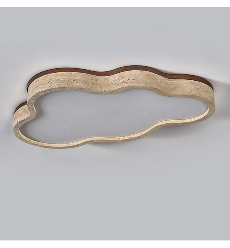 Underside view of the cloud ceiling light showing the porous travertine band