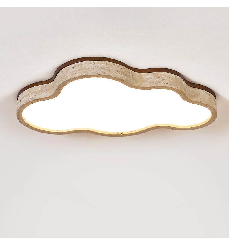 Cloud ceiling light lit flat against a white ceiling with the stone rim visible