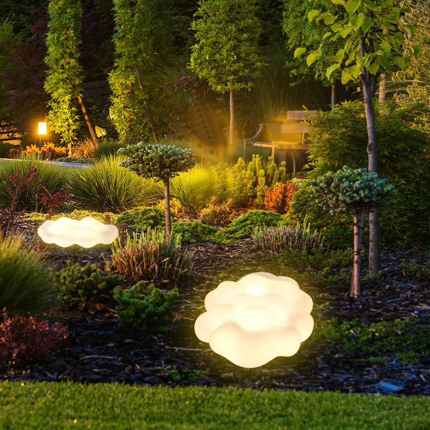 The cloud lit at the edge of a planted border beside a mown lawn