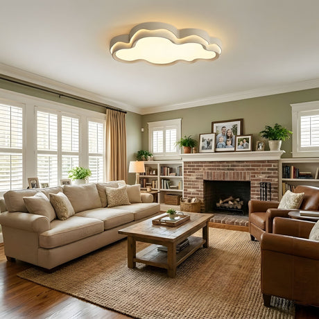 White cloud ceiling fixture over a living room sofa and coffee table lit in the evening