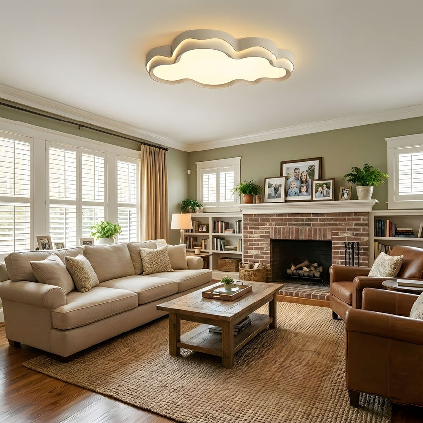 White cloud ceiling fixture over a living room sofa and coffee table lit in the evening