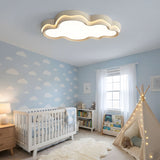 Cloud outline light above a cot in a nursery with pale walls and a soft rug on the floor
