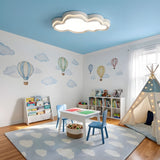White cloud ceiling light in a bedroom above a headboard with bedside tables either side
