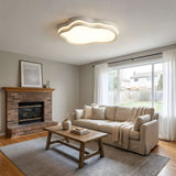 Cloud ceiling fixture lit over a dining area with a sideboard and framed art on the wall