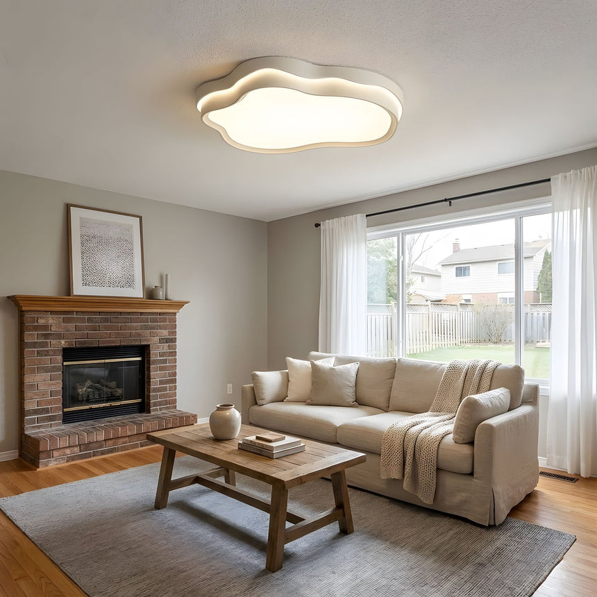 Cloud ceiling fixture lit over a dining area with a sideboard and framed art on the wall