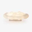 White cloud shaped light on a low base seen against a pale ground