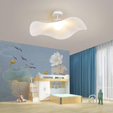 White fabric ceiling fixture in a child room with a blue wall and a painted lotus mural