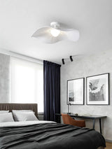 Fabric wing ceiling light above a bed with dark bedding, framed prints and a tall window