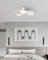 White fabric ceiling fixture over a bed with an upholstered headboard and a framed panel