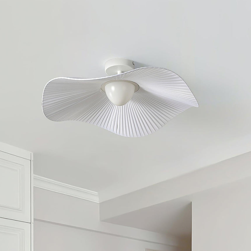 Unlit fabric wing ceiling light mounted near the corner of a plain white ceiling