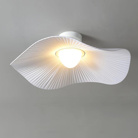 Fabric wing ceiling light lit warm, seen from the side against a gray wall