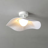 Lit fabric wing ceiling light at a three quarter angle showing the pleated underside