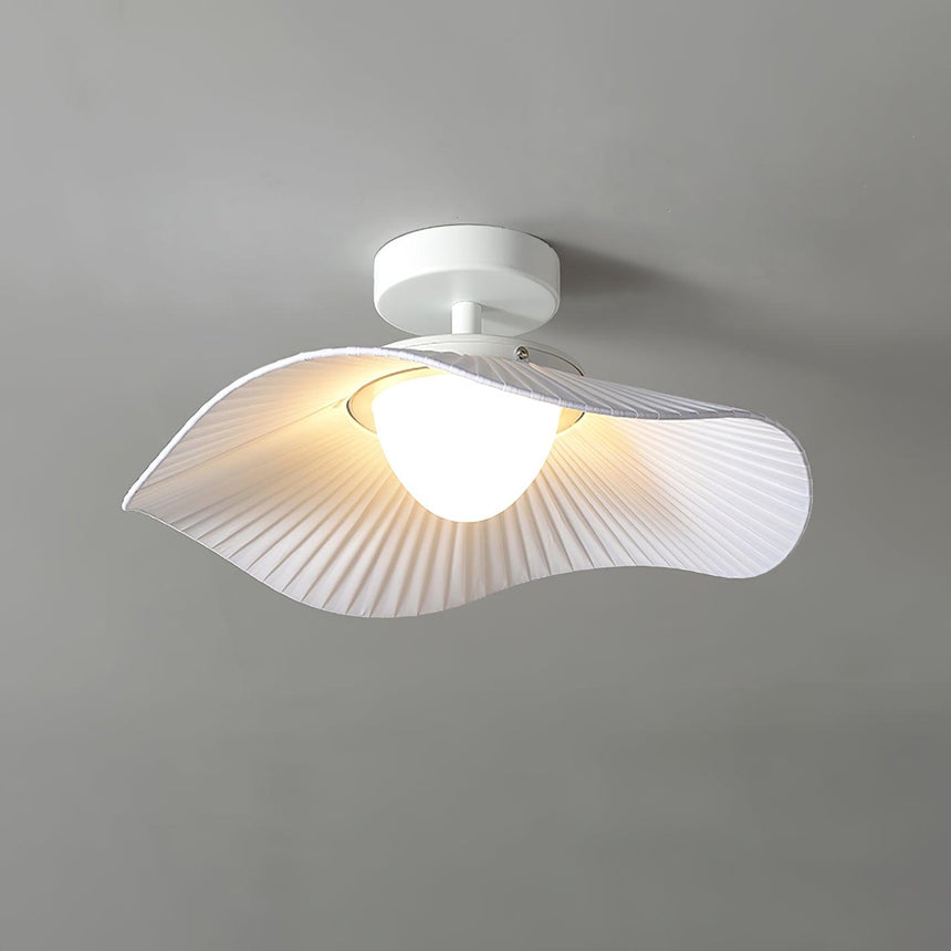 Lit fabric wing ceiling light at a three quarter angle showing the pleated underside