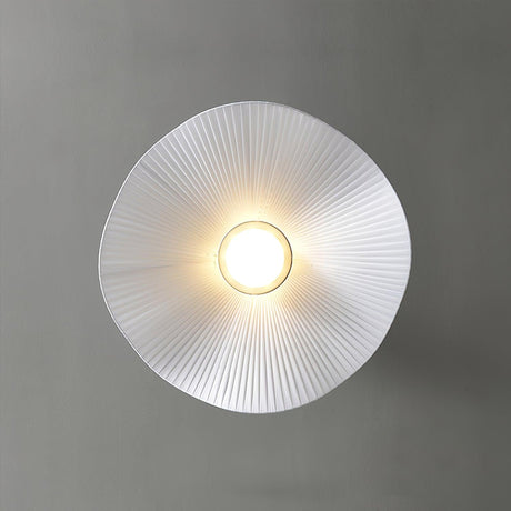 Fabric wing ceiling light seen from directly below with the lamp lit at the center
