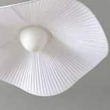 Close view from below of the fabric shade and the small white ceiling canopy