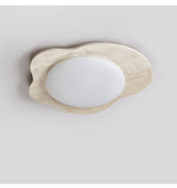 Unlit travertine cloud ceiling light showing the matte white lens against the stone