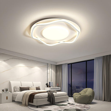 Cloud shaped ceiling lamp lit above a bed in a bedroom with a window wall at night