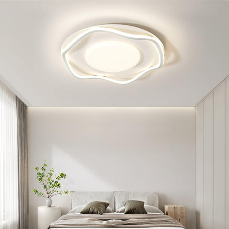 Cloud outline ceiling lamp above a bed with a tall plant and sheer curtains