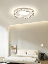 Cloud shaped ceiling lamp lit above a low sofa in a room with an arched alcove