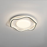 Black and white cloud shaped ceiling lamp lit at an angle against a pale wall