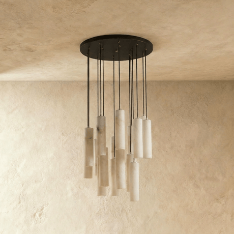 A large cluster of alabaster cylinders unlit, each one on its own black cord