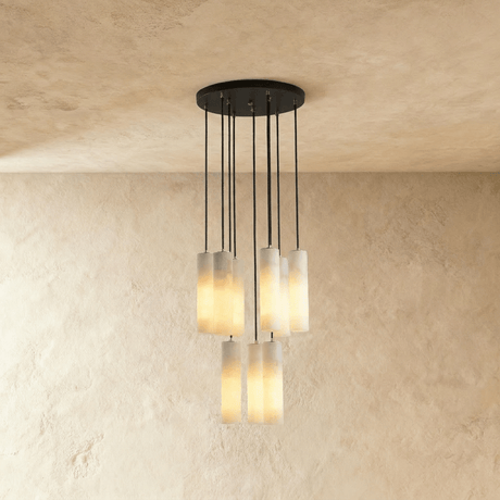 A medium cluster of alabaster cylinders lit at several heights below a plate