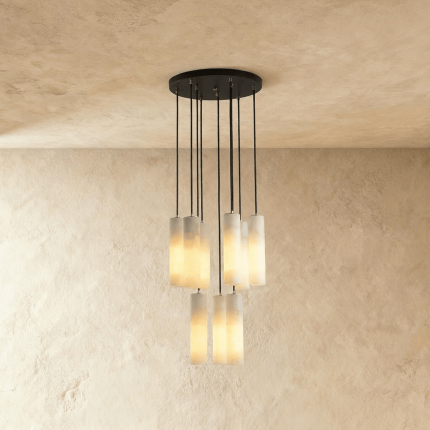 A medium cluster of alabaster cylinders lit at several heights below a plate