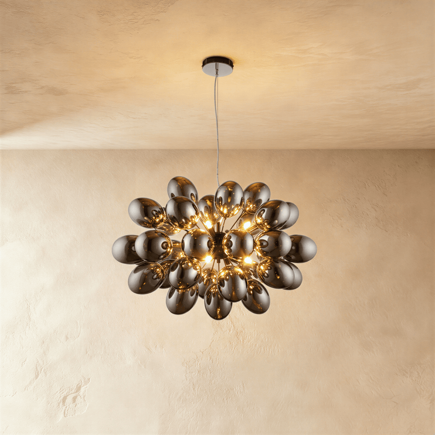 The mirrored cluster lit warm, each ovoid shade catching the light of its neighbor