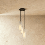 A short cluster of lit alabaster cylinders close under the ceiling plate