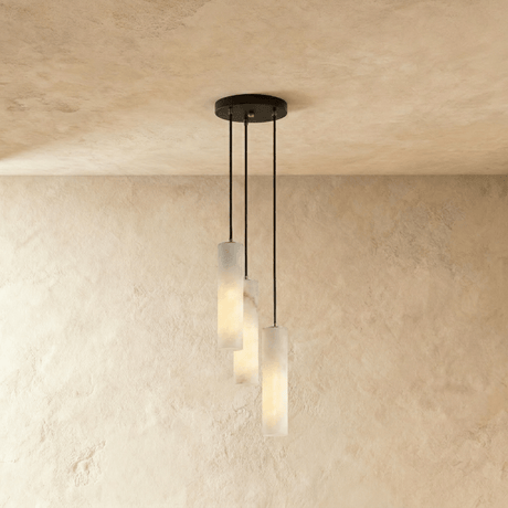A short cluster of lit alabaster cylinders close under the ceiling plate