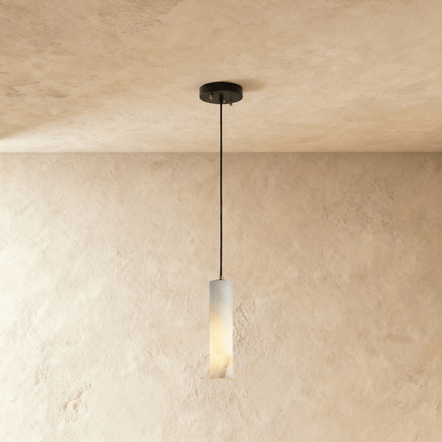 One lit alabaster cylinder on a single black cord below a small plate