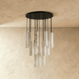 The same wide cluster unlit, the stone cylinders pale against a plaster wall