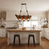 Plank frame lit above a white kitchen island with metal stools