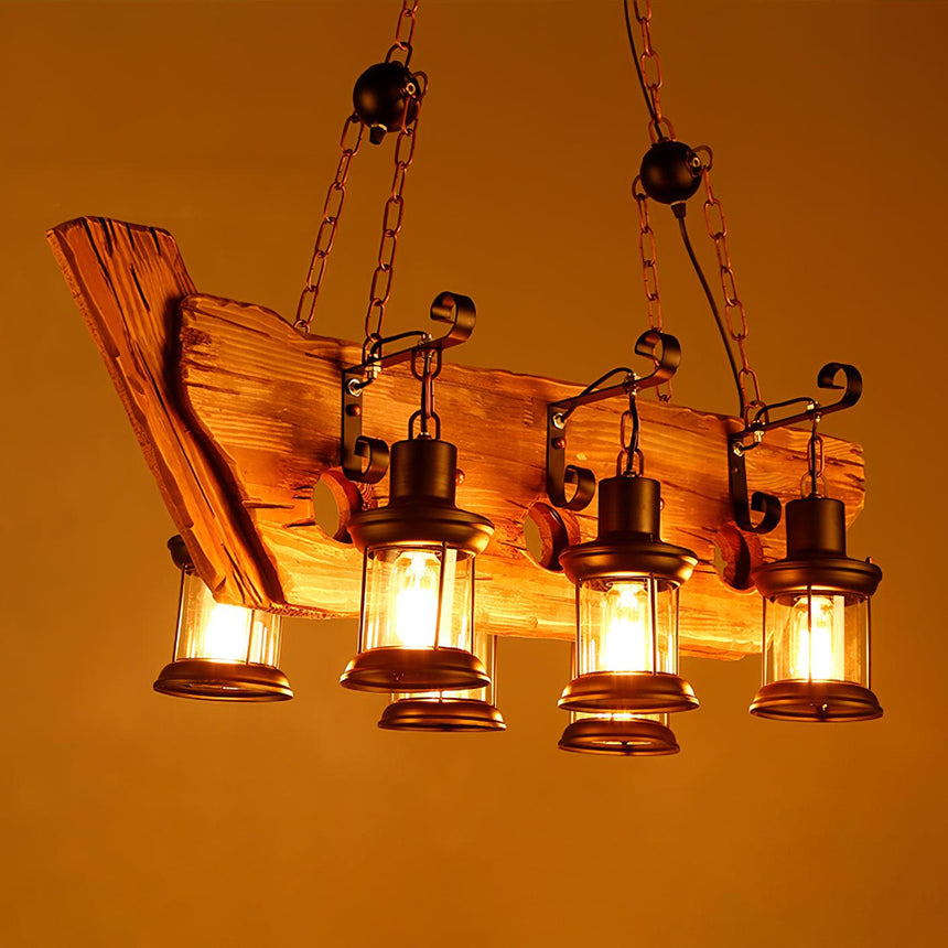 A long plank frame with several lanterns lit warm along its length