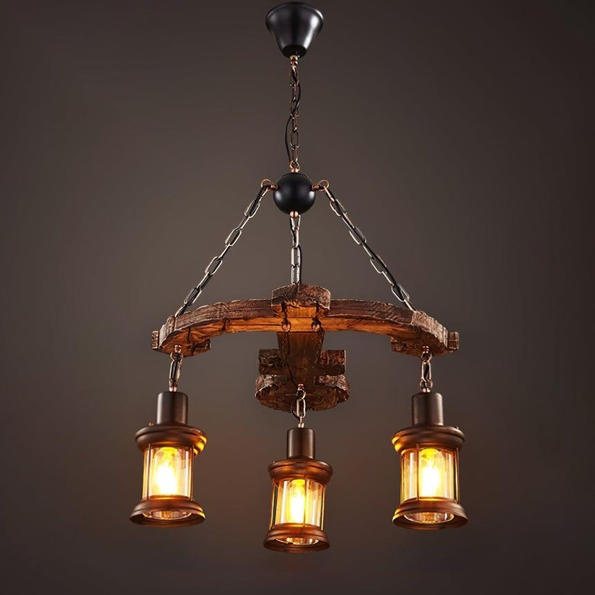 Three glass lanterns hung from a round wood frame on chains