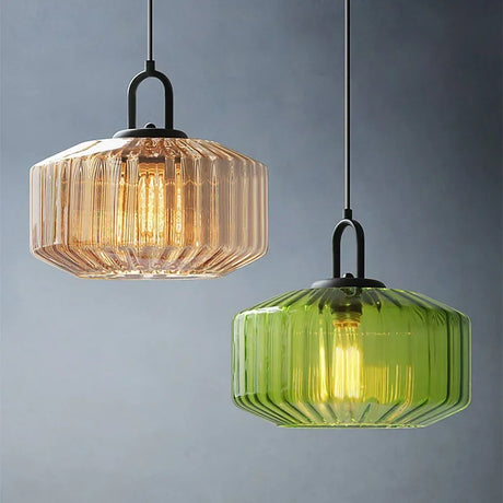 Amber and green ribbed drums hanging at two heights on a blue gray wall