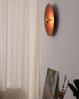 The orange disc seen from the side beside a curtain