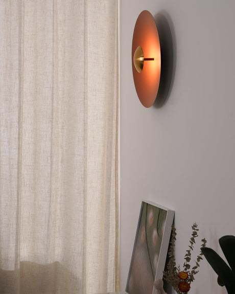 The orange disc seen from the side beside a curtain