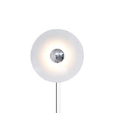 The white disc with a chrome center and its cord on a white background